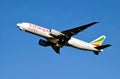 white, red and green Ethiopian cargo plane taking off from the Budapest airport. blue sky.