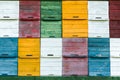 White, red, green, yellow and blue honey beekeeping boxes. Colorful honey beekeeping boxes