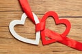 A white and red heart bind together with a red ribbon