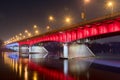 White and red illuminated at Slasko-Dabrowski bridge over Vistula River at night in Warsaw, Poland Royalty Free Stock Photo