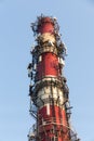White-red industrial chimney with antennas Royalty Free Stock Photo
