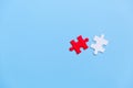 White and red jigsaw puzzle on a blue background. Copy space for text, top view, close up Royalty Free Stock Photo