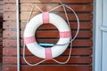 White and red Lifebuoy Ring hanging on wooden wall Royalty Free Stock Photo