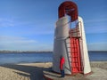 White red lifeguard tower stands on empty river beach in winter day Royalty Free Stock Photo