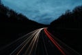 White and red light trails of moving vehicles die to long exposure during blue hours at a motorway Royalty Free Stock Photo