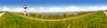 White and red Lighthouse and the water of the Elbe river in Germany. Panorama. Royalty Free Stock Photo