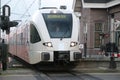 White and red local commuter train between Dordrecht and Geldermalsen at Arkel station runned