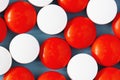 White and red medicine pills on blue background. Close up, top view Royalty Free Stock Photo