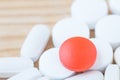 White and red medicine pills on a wooden Royalty Free Stock Photo