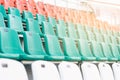 White, red and mint-colored plastic seats, arranged in rows in a stadium Royalty Free Stock Photo