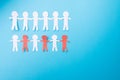 White and red paper people holding hands. Blue background. Froma bove Royalty Free Stock Photo