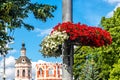 Lamppost decorated with white and red petunias