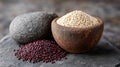 White and red quinoa in rustic stone bowls on a textured surface. Royalty Free Stock Photo