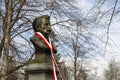 White and red ribbon adorns the monument