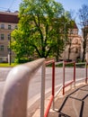 White-red safety railings on the sidewalk at the intersection