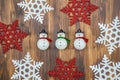 White and red shiny snowflakes and snowman decoration on wood Royalty Free Stock Photo