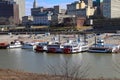 White and red steam boats docked on the banks in the Wolf Creek Harbor with a view of the skyscrapers and  office buildings Royalty Free Stock Photo