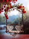 A white and red swing is adorned with flowers and sits in front of a blue wall. Royalty Free Stock Photo