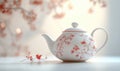 A white and red tea pot with flowers on it Royalty Free Stock Photo