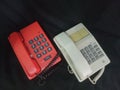 white and red telephones on a black background, close-up of the phone