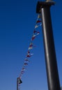 White and red triangular signal flags on a blue sky background. Royalty Free Stock Photo