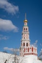White and red watchtower and white wall against the background of the bell tower of the Novodevichy Convent, Moscow Royalty Free Stock Photo