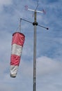 White and red windsock isolated on blue sky background. Check the wind blow direction concept Royalty Free Stock Photo