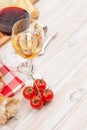 White and red wine, cheese and bread on white wooden table background Royalty Free Stock Photo