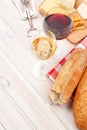 White and red wine, cheese and bread on white wooden table background Royalty Free Stock Photo