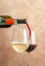 White and red wine pouring into glasses Royalty Free Stock Photo