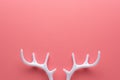 White reindeer antlers on bright pink background. Minimal New Year or Christmas concept. Flat lay Royalty Free Stock Photo