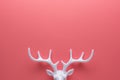 White reindeer antlers on bright pink background. Minimal New Year or Christmas concept. Flat lay Royalty Free Stock Photo