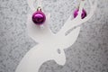 White reindeer with two christmas ornament balls Royalty Free Stock Photo