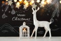 White reindeer on wooden table over chalkboard background whith hand drawn chalk illustrations Royalty Free Stock Photo