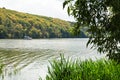 White relax boat and bank of river with lush green and yellow forest. Scenic, beautiful, background Royalty Free Stock Photo