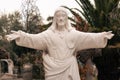 white religious statue figure of christ opening his arms