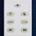 White remote control with the buttons on the blue background Royalty Free Stock Photo