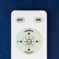 White remote control with the buttons on the blue background Royalty Free Stock Photo