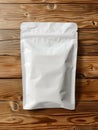 White resealable packaging bag mockup on wooden background.