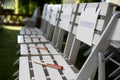 White reserved sign on white chair at outdoor wedding Royalty Free Stock Photo