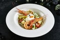 White Restaurant Plate of Caesar Salad with Shrimps, Chicken, Croutons, Tomatoes, Cucumbers Top View Royalty Free Stock Photo