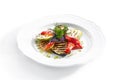 White Restaurant Plate of Grilled Vegetables and Fresh Greens Isolated