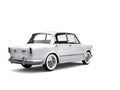 White restored vintage compact car - back view