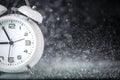 White retro alarm clock in a black background under the water drops.. Morning. Break. Motivation. Business solutions. Success. Royalty Free Stock Photo