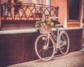 White retro bicycle standing against the wall, tinted photo Royalty Free Stock Photo