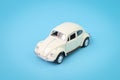 White retro car toy model isolated on a blue background Royalty Free Stock Photo