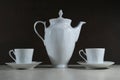 White retro coffee or tea pot with cups on dark background Royalty Free Stock Photo