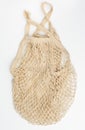 white reusable string bag woven from thread on white background