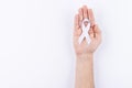 White ribbon over palm. White background