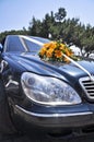 Bouquet on the hood of the wedding car Royalty Free Stock Photo